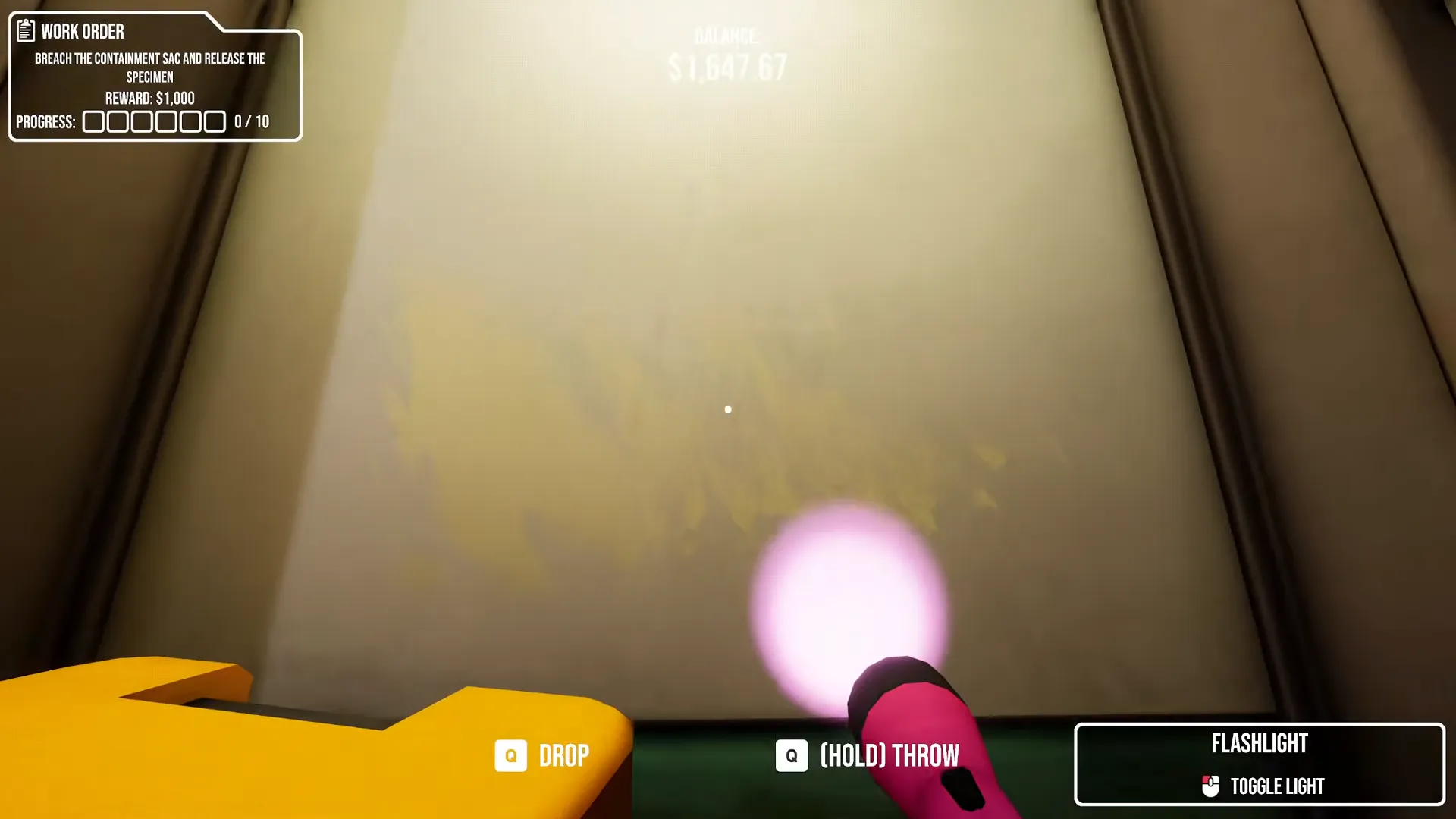 Purple flashlight beam illuminating faint yellow writing on a lab wall